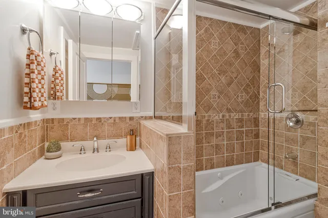 a bathroom with a sink a mirror and a shower