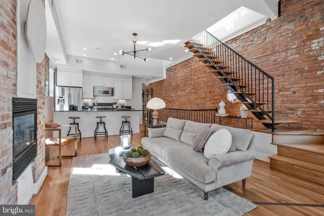 a living room with furniture and kitchen view