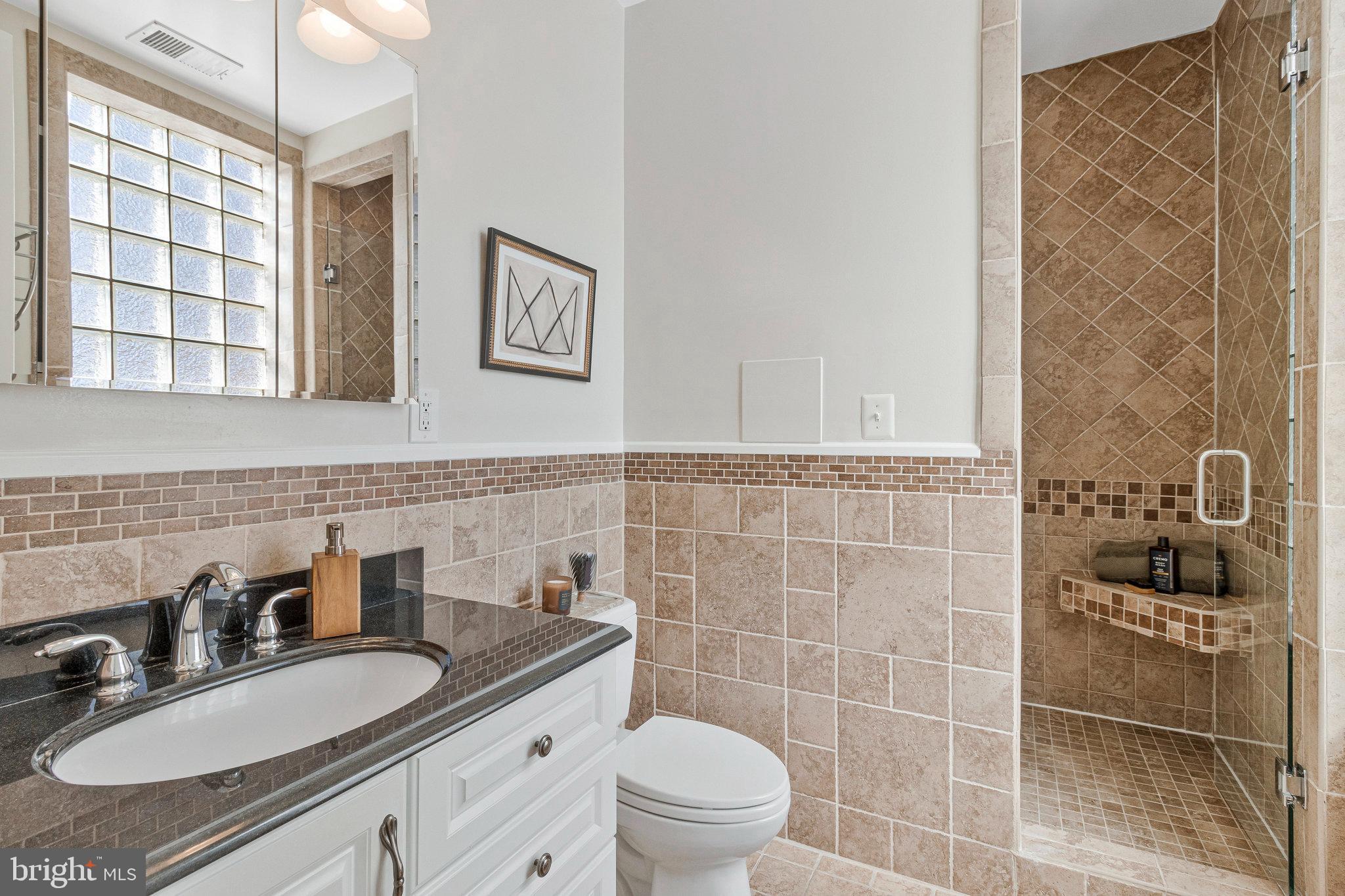 1312 Florida Avenue Northwest, Unit 3 Washington, DC 20009 - Photo 8 of 18 a bathroom with a sink a toilet and a mirror