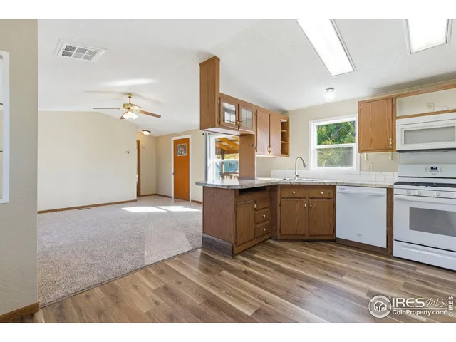 a kitchen with a sink cabinets and window