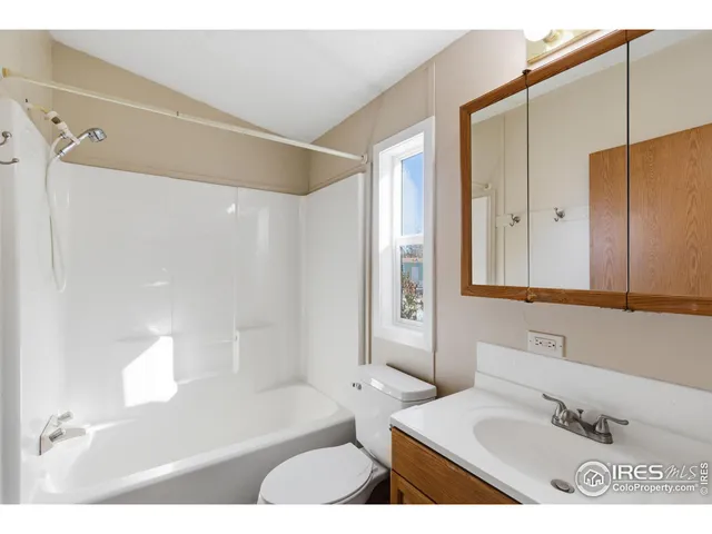 a bathroom with a tub a sink and a mirror