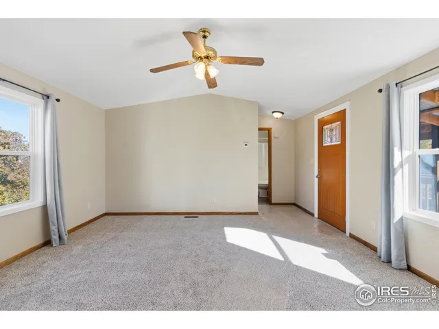 a view of a livingroom with a ceiling fan and window