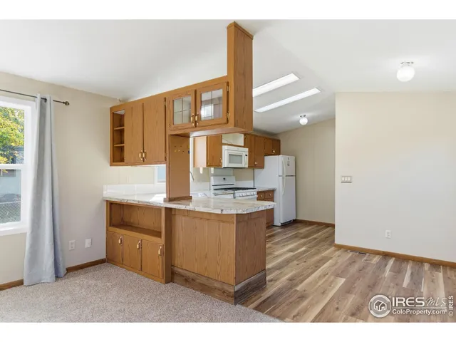 a view interior of kitchen and hall with wooden floor