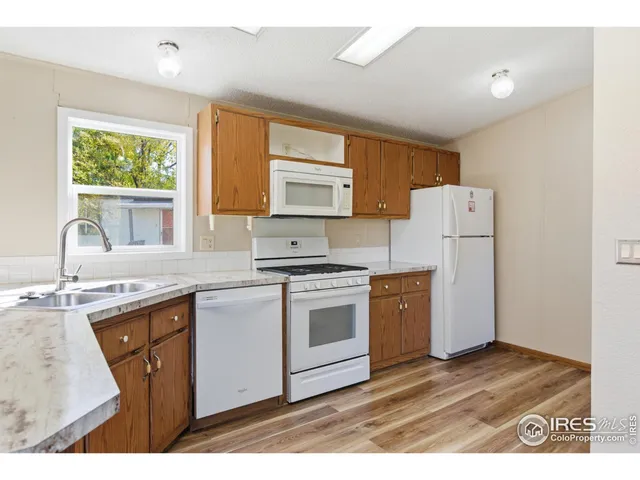 a kitchen with a stove a sink and a refrigerator