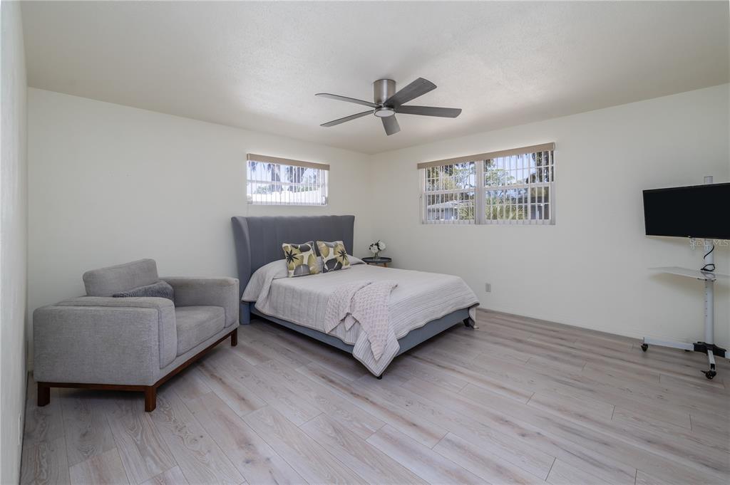 1016 Cherokee Ranch Road Holly Hill, FL 32117 - Photo 13 of 23 a bedroom with a bed and a flat screen tv