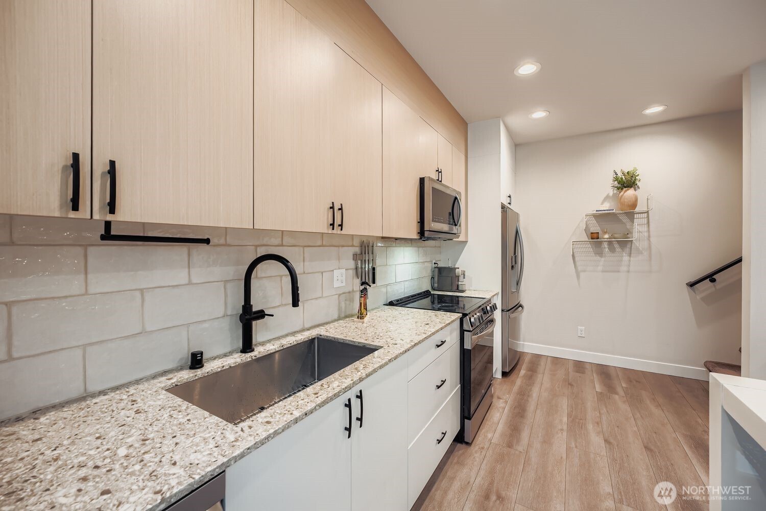 1605 South Washington Street, Unit F Seattle, WA 98144 - Photo 11 of 22 a kitchen with stainless steel appliances granite countertop a sink a stove and a wooden floors