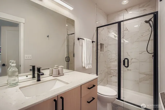 a bathroom with a sink toilet and shower