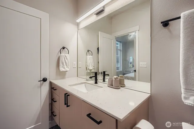a bathroom with a sink vanity granite and a mirror