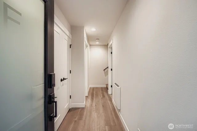 a view of hallway with wooden floor