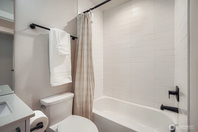 a bathroom with a toilet and a bathtub