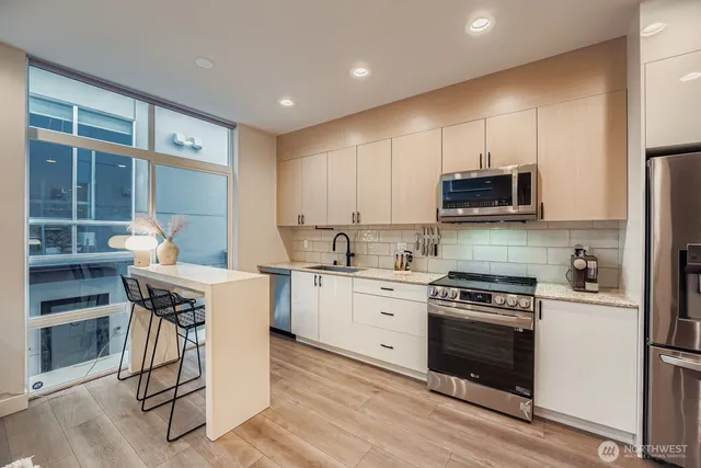 a kitchen with a stove a sink and a refrigerator