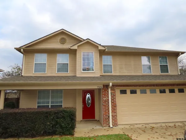 a front view of a house with yard