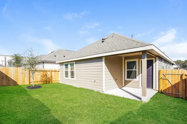 a backyard of a house with table and chairs