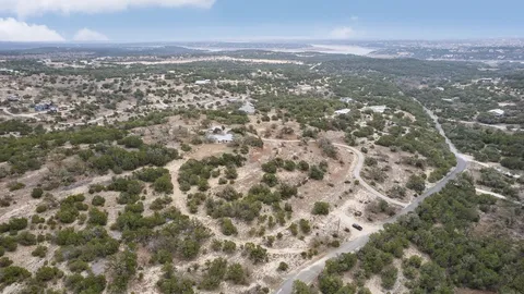 an aerial view of residential houses with city view