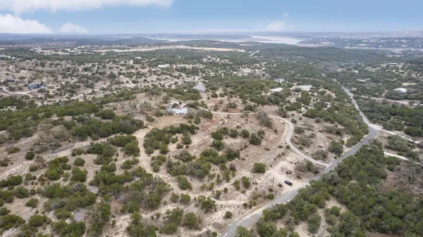 an aerial view of residential houses with city view