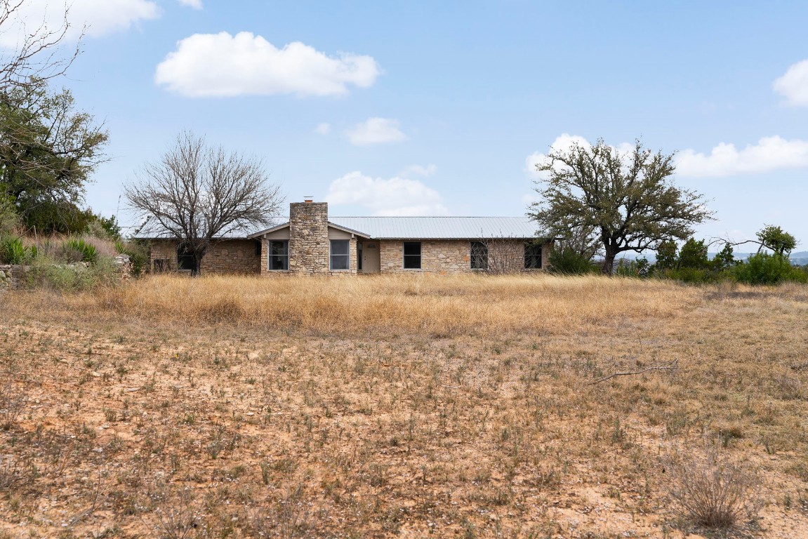 21418 Kathy Lane Spicewood, TX 78669 - Photo 19 of 40 a front view of a house with a yard and garage