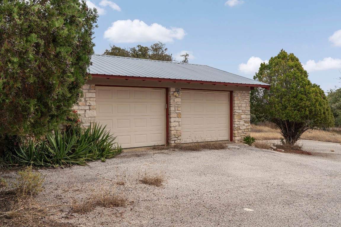 21418 Kathy Lane Spicewood, TX 78669 - Photo 7 of 40 a view of a house with a yard and garage