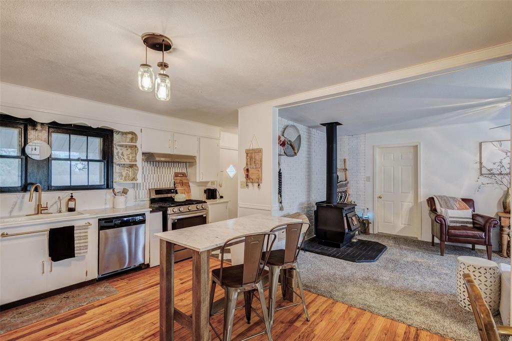 440 South Main Street Springtown, TX 76082 - Photo 11 of 33 a view of a dining room with furniture and wooden floor