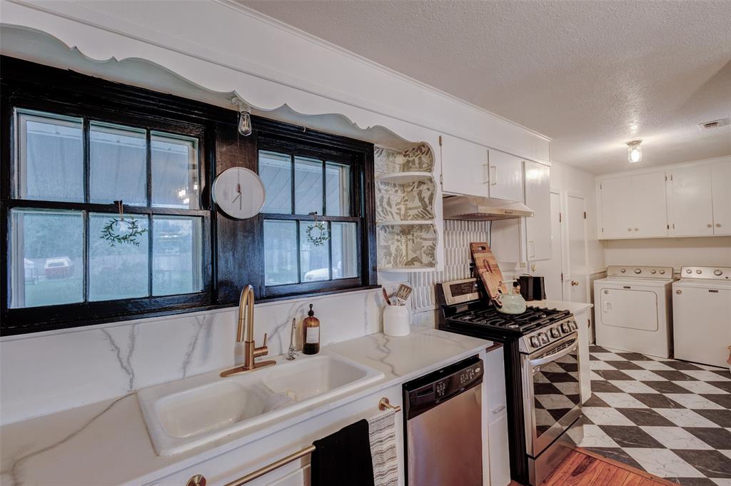 440 South Main Street Springtown, TX 76082 - Photo 13 of 33 a kitchen with a sink cabinets and window