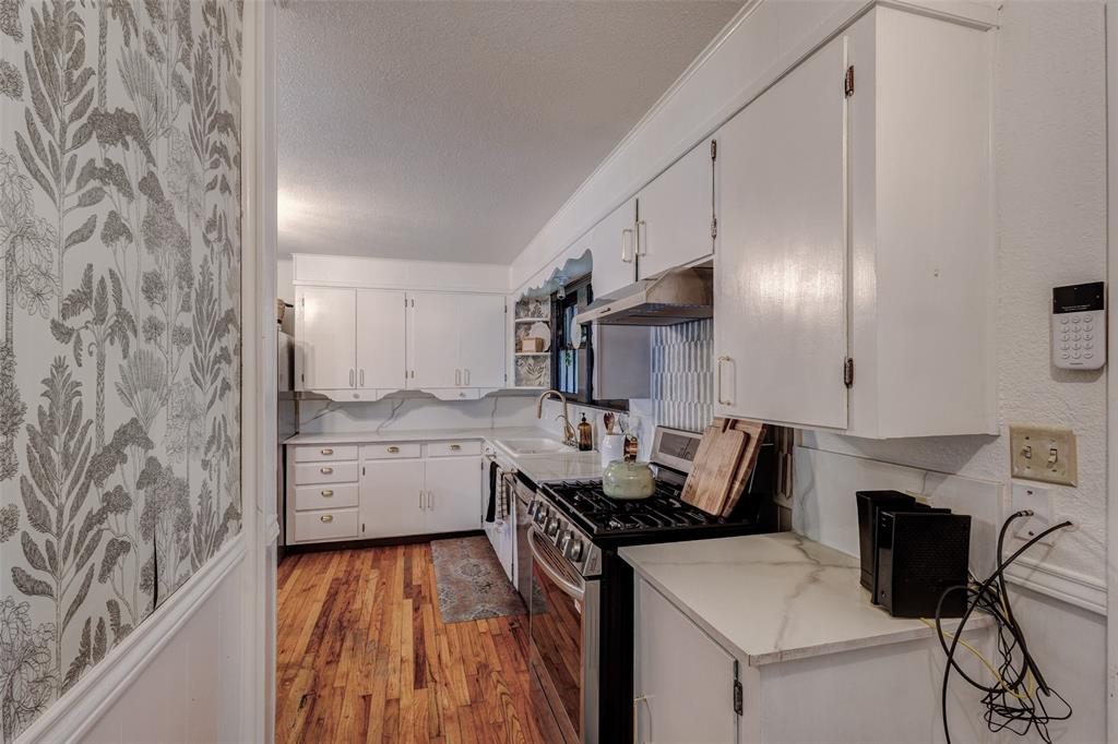 440 South Main Street Springtown, TX 76082 - Photo 16 of 33 a kitchen that has a sink and a stove