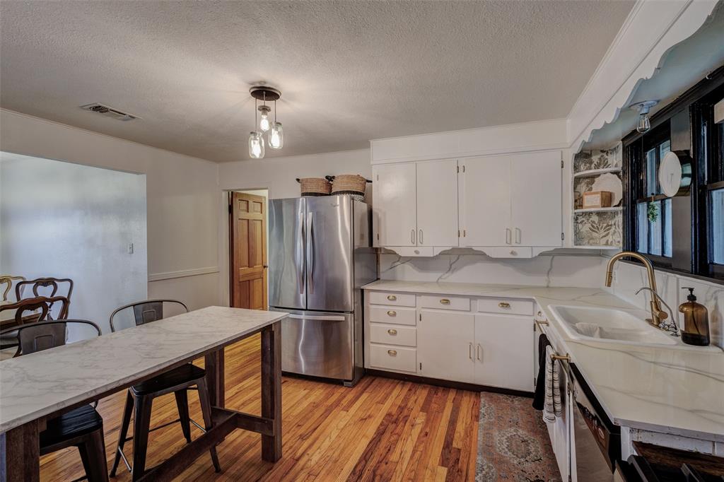 440 South Main Street Springtown, TX 76082 - Photo 17 of 33 a kitchen with sink cabinets and refrigerator