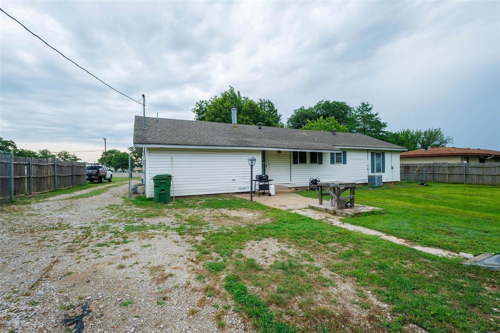 440 South Main Street Springtown, TX 76082 - Photo 23 of 33 a view of a house with backyard and a tree