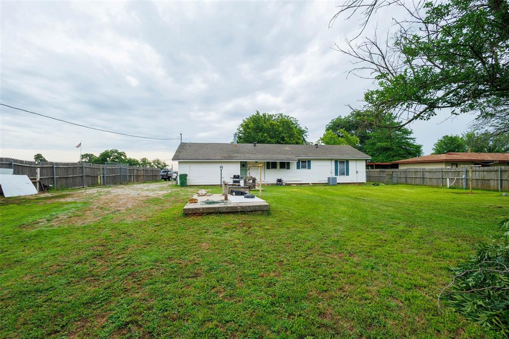 440 South Main Street Springtown, TX 76082 - Photo 24 of 33 a view of a house with a yard