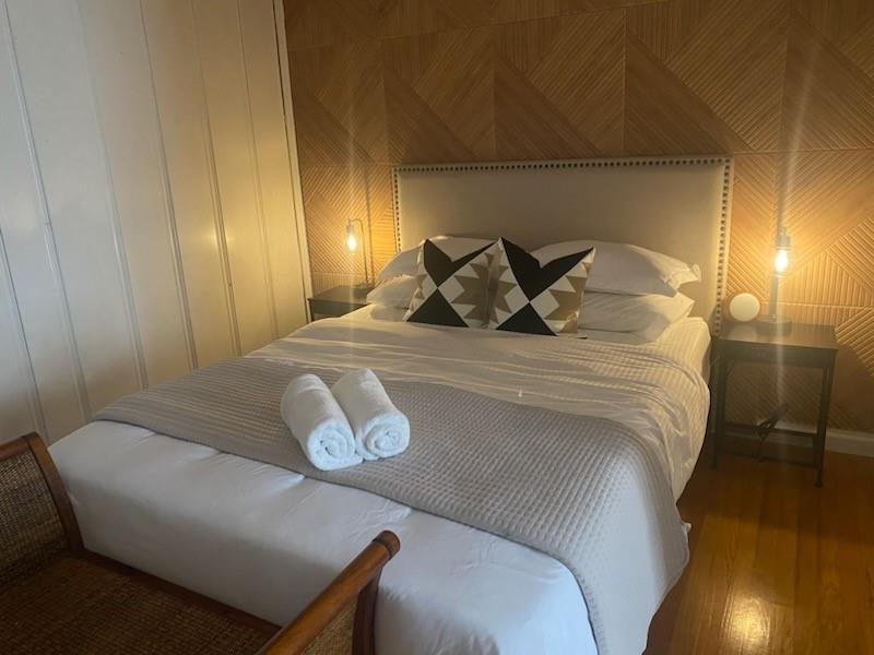 440 South Main Street Springtown, TX 76082 - Photo 31 of 33 a bedroom with a bed and wooden floor