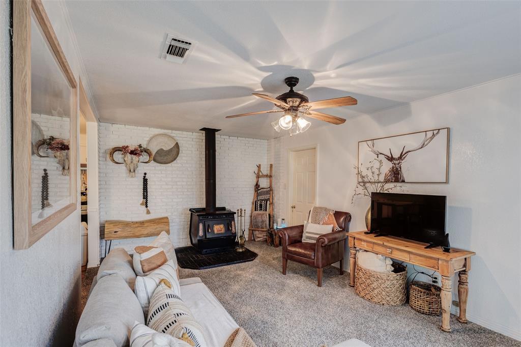 440 South Main Street Springtown, TX 76082 - Photo 6 of 33 a living room with furniture and a flat screen tv