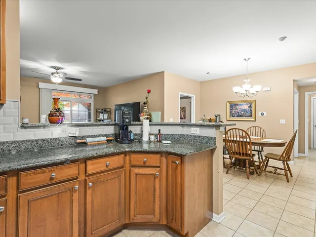 a kitchen with granite countertop sink cabinets and stainless steel appliances