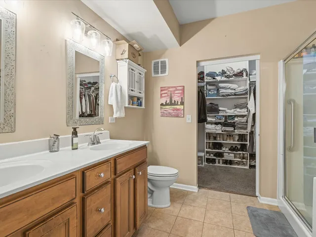 a spacious bathroom with a sink a toilet and shower
