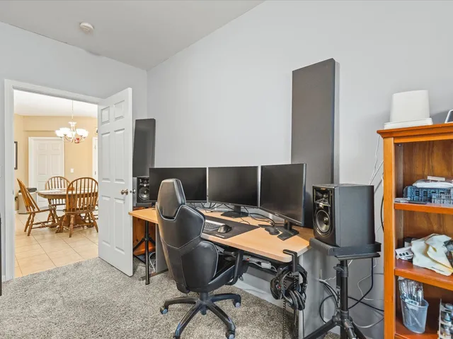 a view of a workspace with furniture and a gate