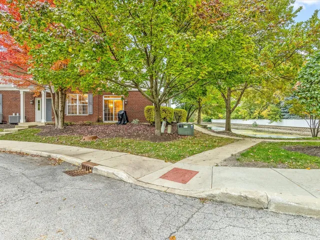 a view of a brick house with a garage