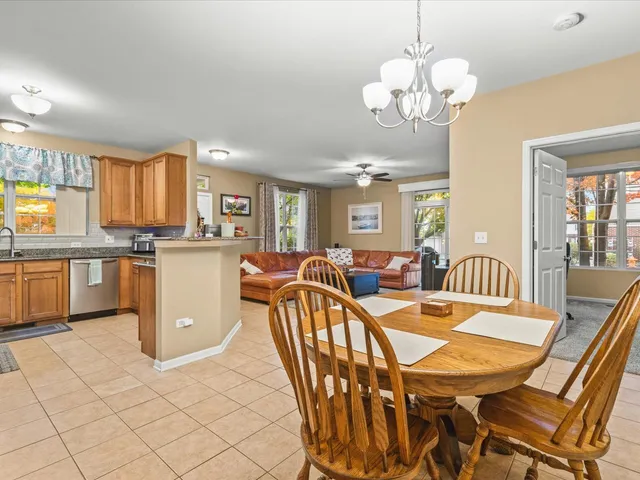a view of a dining room with furniture and a chandelier