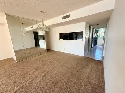 a utility room with a sink a vanity and a mirror