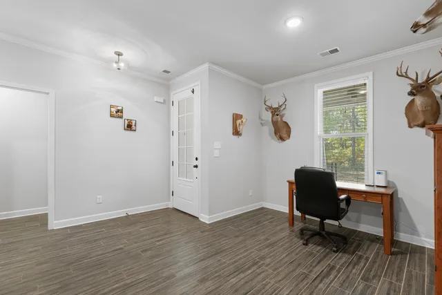 a view of a workspace with furniture and a window