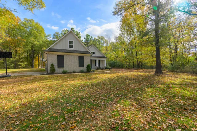 a front view of house with yard and green space