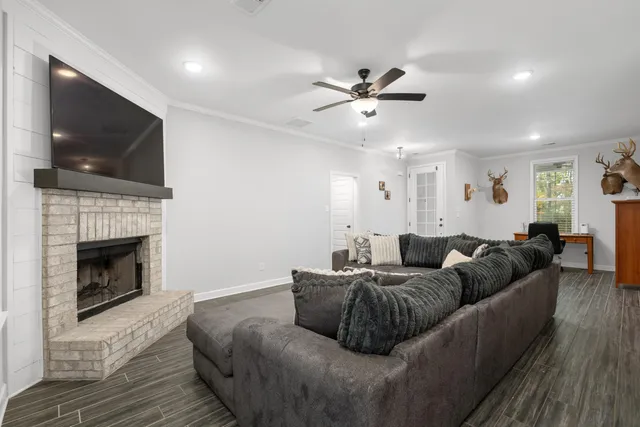 a living room with furniture a flat screen tv and a fireplace