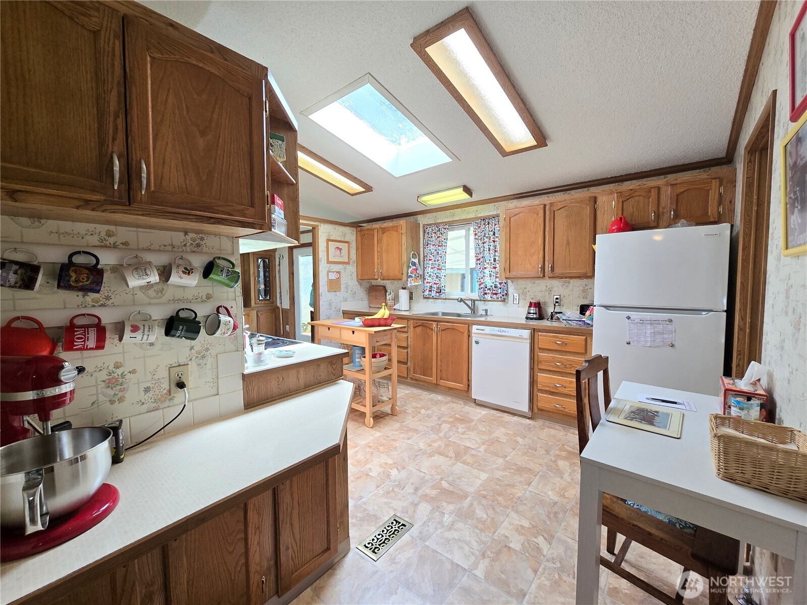 57 Clemons Road, Unit 12 Montesano, WA 98563 - Photo 11 of 30 a kitchen with a sink refrigerator and cabinets