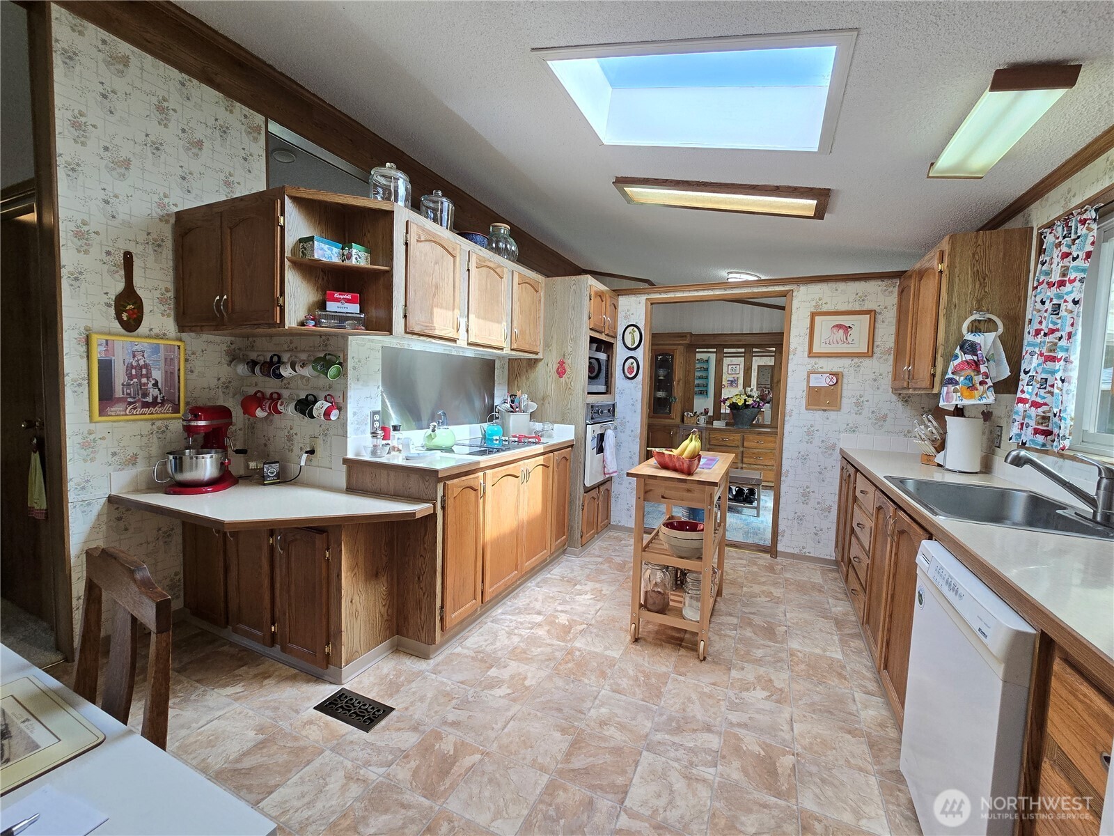 57 Clemons Road, Unit 12 Montesano, WA 98563 - Photo 12 of 30 a room with stainless steel appliances kitchen island granite countertop furniture and a sink