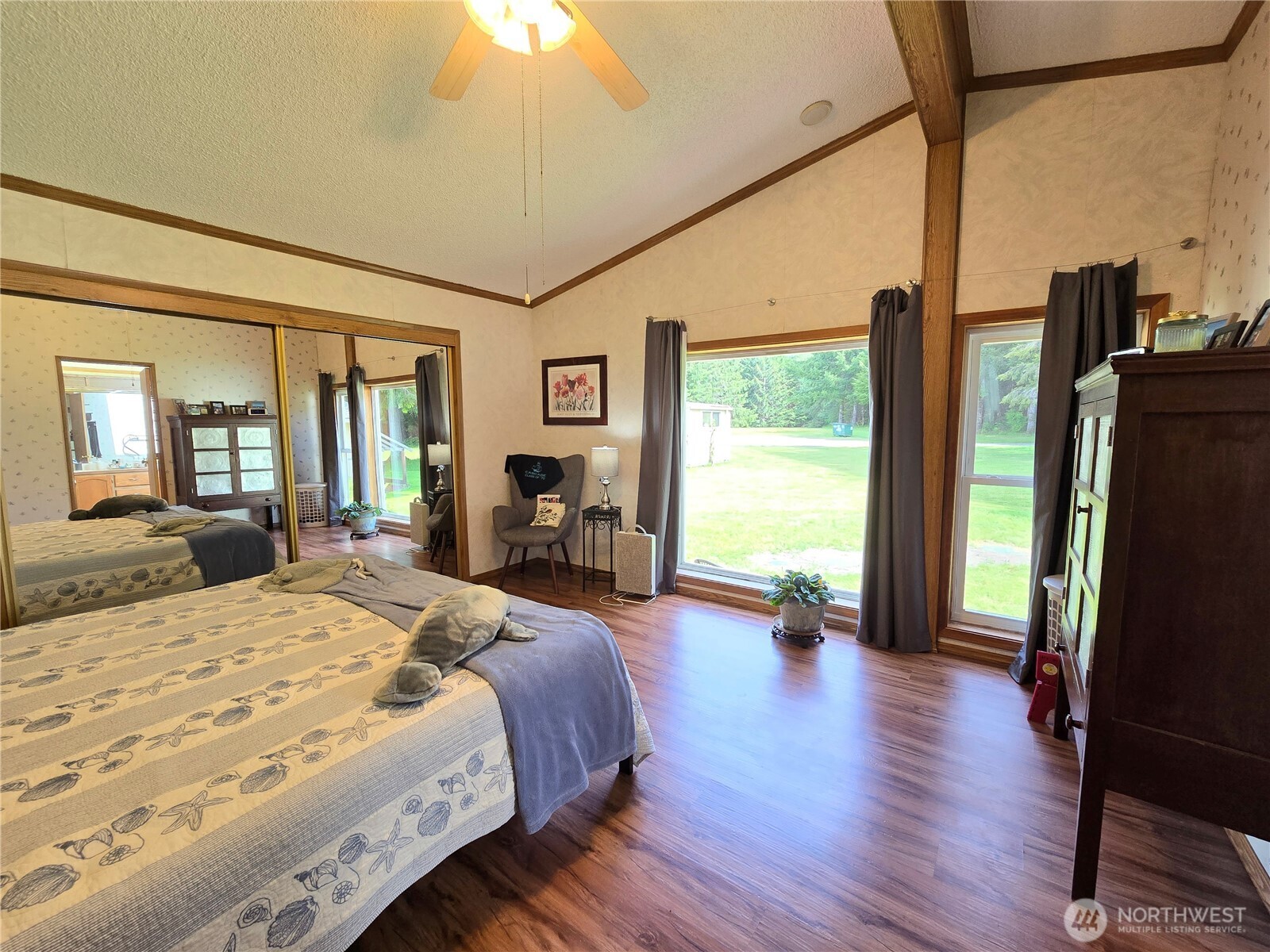 57 Clemons Road, Unit 12 Montesano, WA 98563 - Photo 16 of 30 a spacious bedroom with a bed a large window and wooden floor