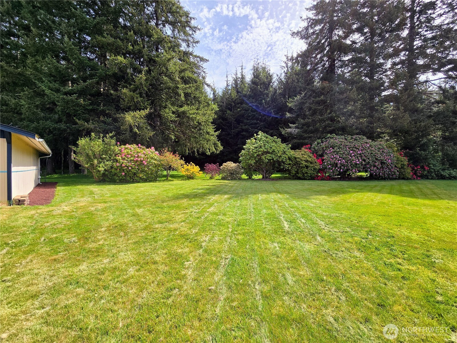 57 Clemons Road, Unit 12 Montesano, WA 98563 - Photo 2 of 30 a view of a garden with a bench