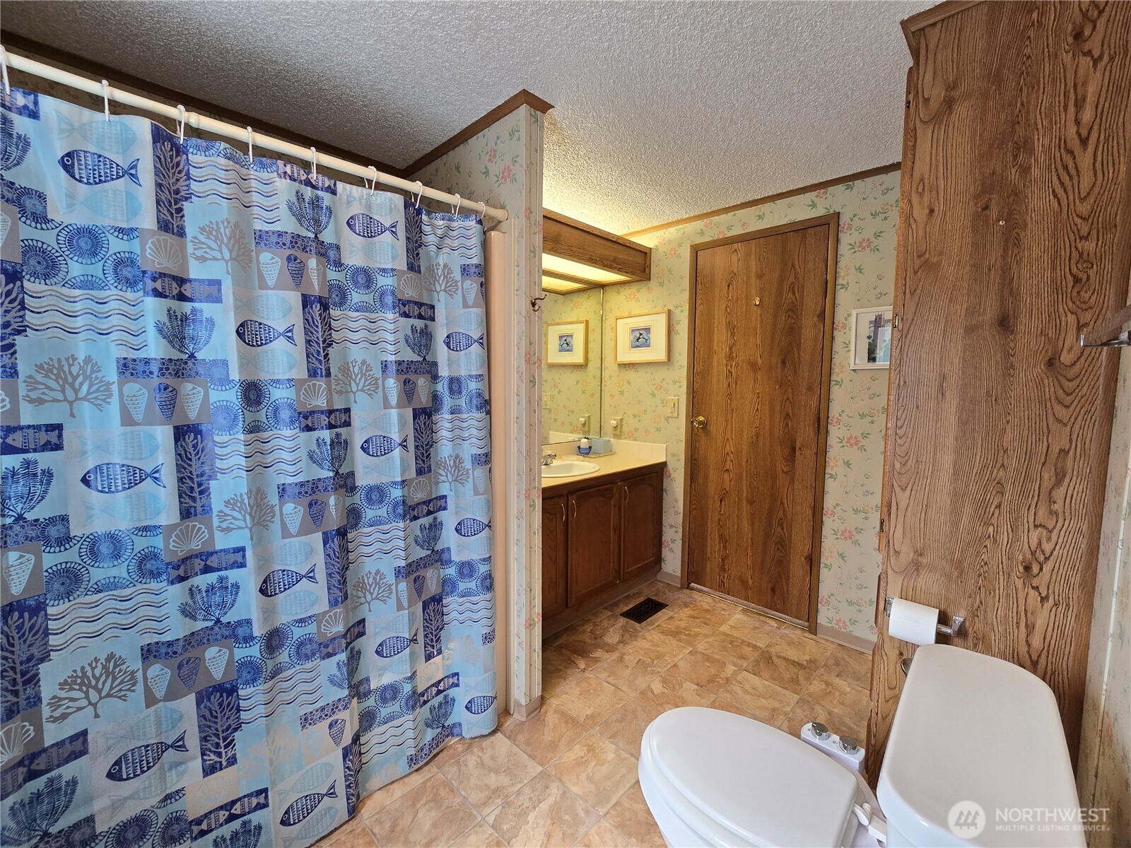 57 Clemons Road, Unit 12 Montesano, WA 98563 - Photo 26 of 30 a bathroom with a sink toilet and shower