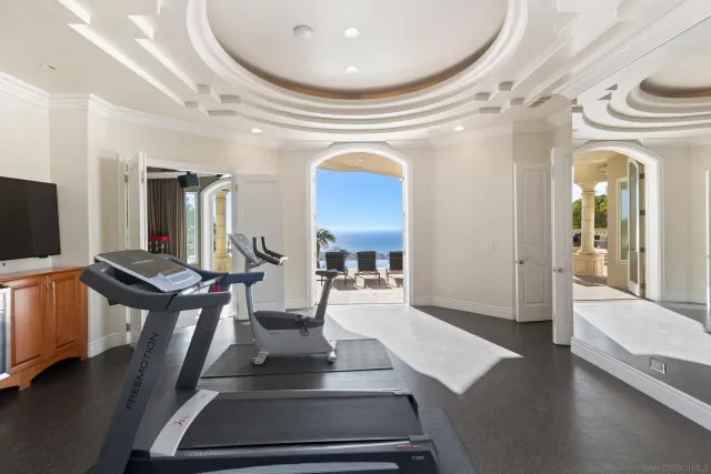 a view of hall way with furniture and large windows