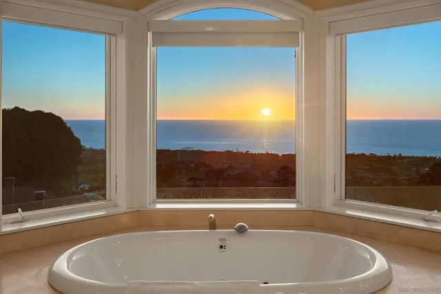 a bath tub sitting in a bathroom next to a window