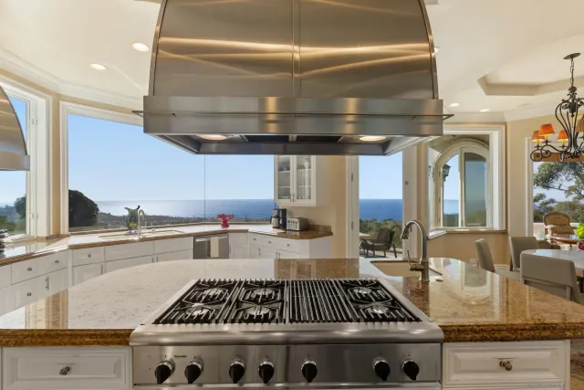 a kitchen with granite countertop a stove and cabinets