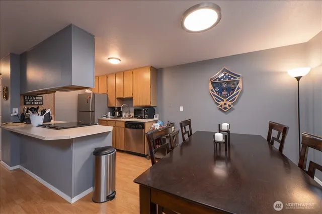 a kitchen with a table chairs and a refrigerator