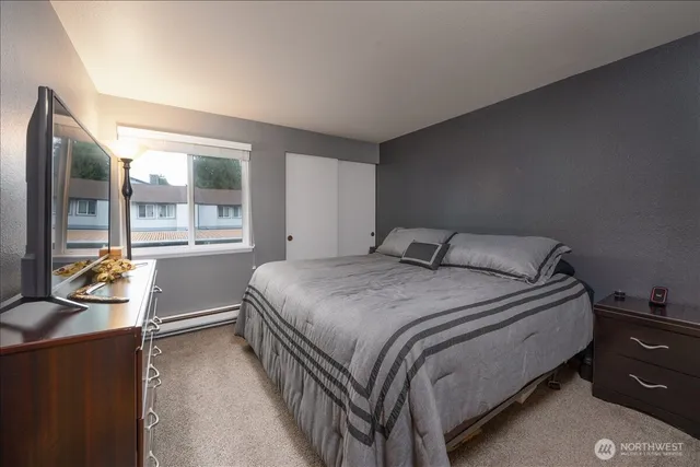a bedroom with a bed and glass window