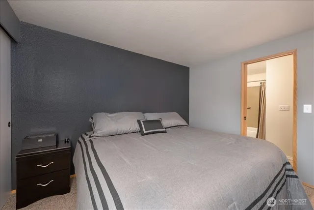 a bedroom with a bed and a night stand