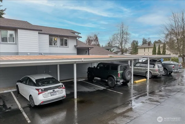 a view of a roof deck with table and chairs a barbeque